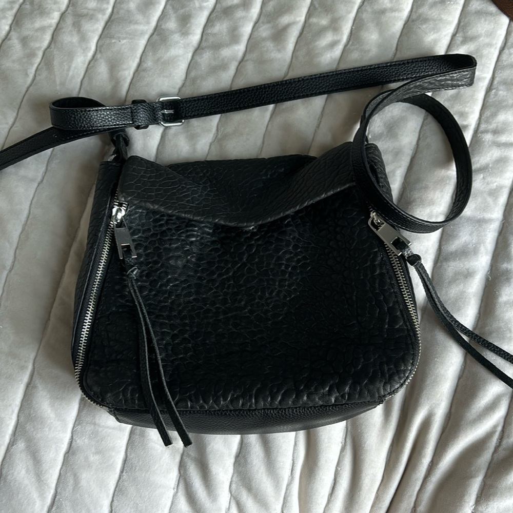 Black leather crossbody purse with silver accents